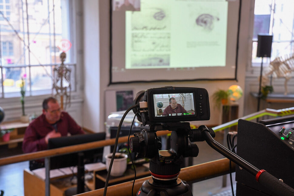 Online Lecture mit Ph.D. Till Ansgar Baumhauer Till Ansgar Baumhauer vor Leinwand
