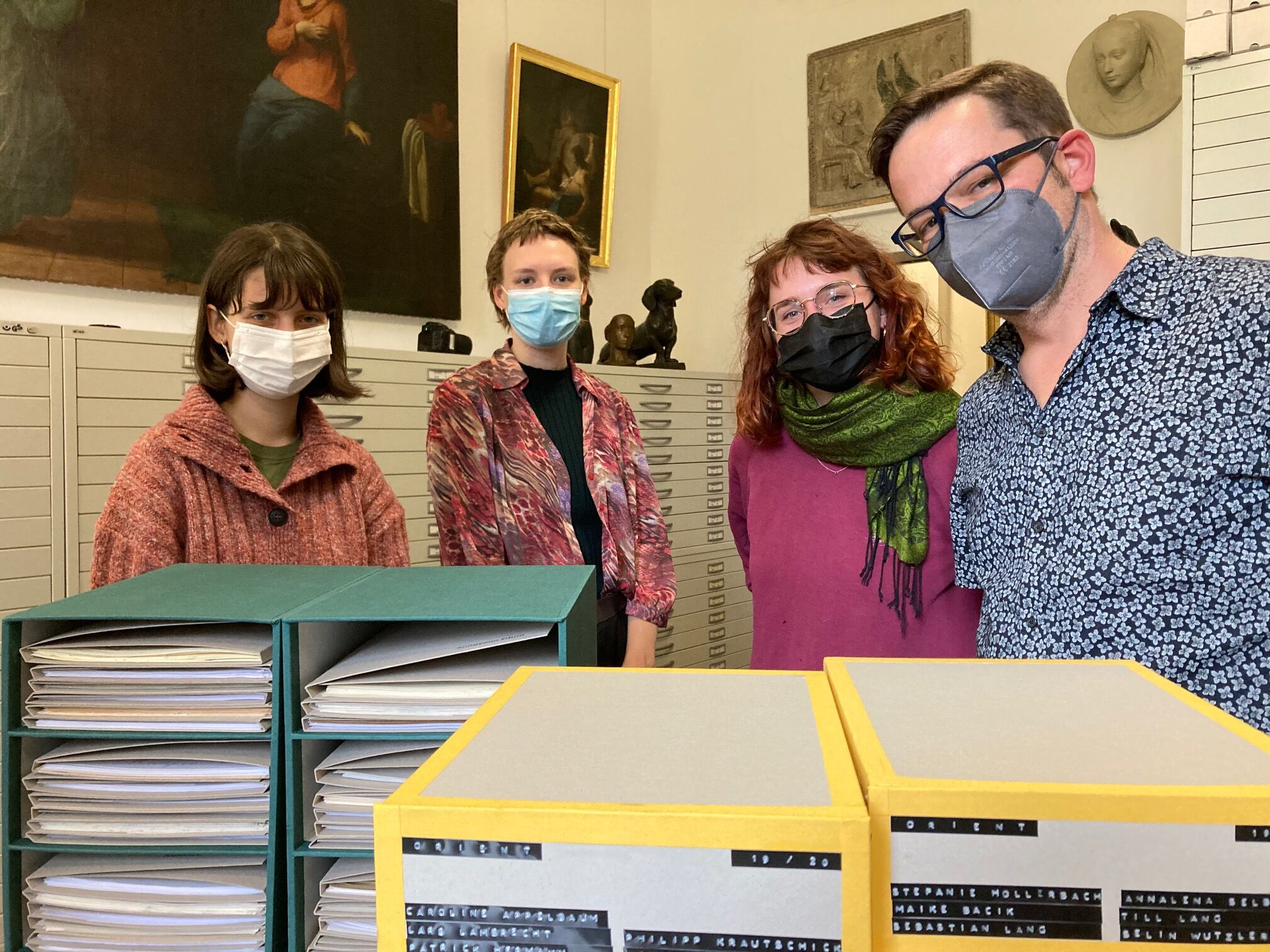 Group photo of the handover of the slipcases to the university’s archive.